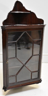 Lot 1251 - An Edwardian mahogany corner cabinet, with...