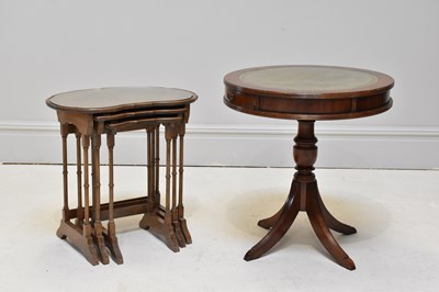 Lot 1128 - A reproduction mahogany drum table with green...