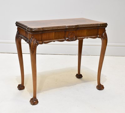 Lot 1149 - A carved walnut card table, the hinged top...