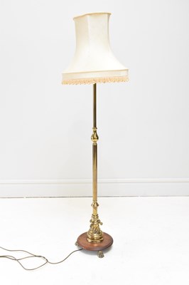 Lot 1681 - A brass standard lamp, with circular wooden...