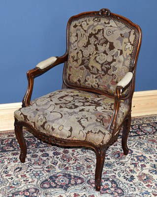 Lot 2925 - A French carved open sided elbow chair with...