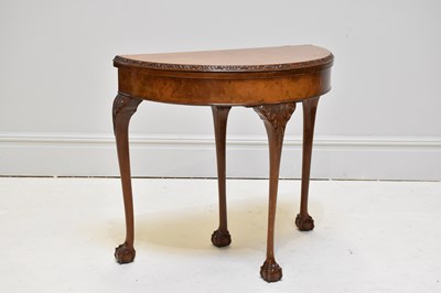 Lot 1186 - A reproduction carved walnut demi-lune card...