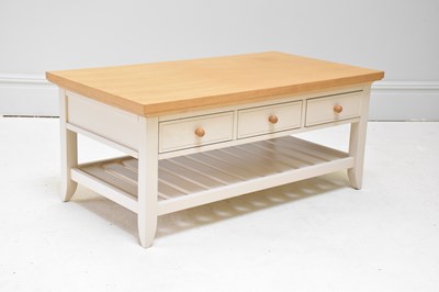 Lot 1120 - A modern three drawer coffee table, on block...
