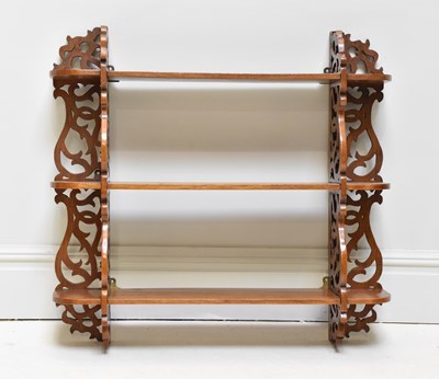 Lot 1270 - A mahogany hanging shelf, with three open...
