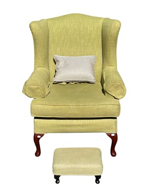 Lot 1217 - A George III style wing back library chair,...