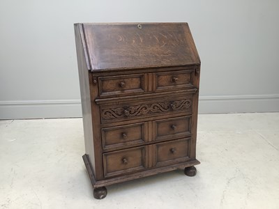 Lot 1138 - A reproduction oak bureau, with an arrangement...
