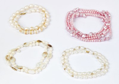 Lot 1469 - Four pearl necklaces, comprising a pink...