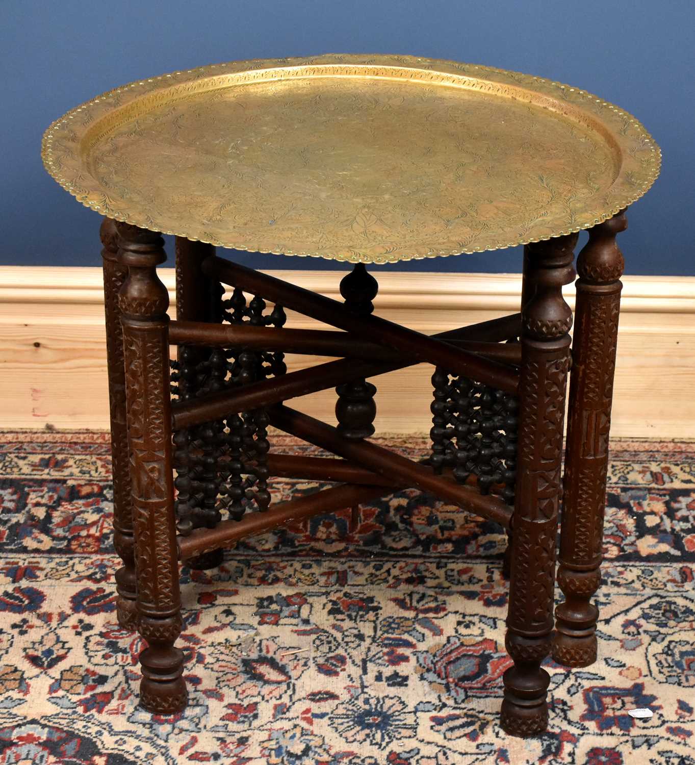 Lot 2855 - An Eastern brass top Benares table on folding...