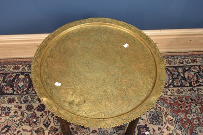 Lot 2855 - An Eastern brass top Benares table on folding...