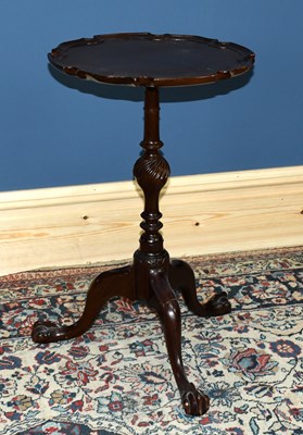 Lot 3071 - A 1950s mahogany tripod table on ball and claw...