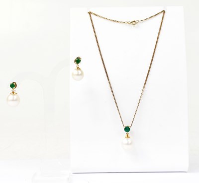 Lot 1480 - An 18ct yellow gold pendant set with a green...