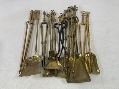Lot 177 - A collection of 19th century brass fire tools...