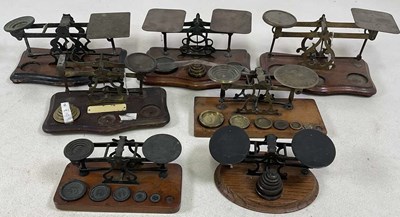Lot 108 - Seven sets of brass wooden based postal scales.