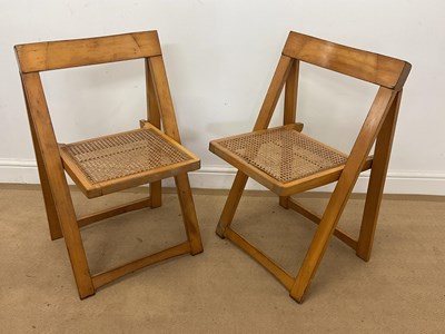 Lot 779 - A pair of beech and rattan folding chairs.