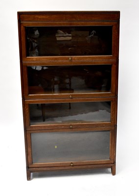 Lot 25 - An early 20th century oak four-section...