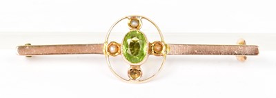 Lot 1394 - A 9ct yellow gold bar brooch set with a green...