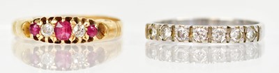 Lot 1309 - An 18ct yellow gold ring set with three red...