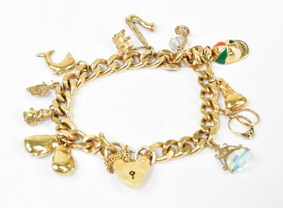 Lot 1406 - A 9ct yellow gold charm bracelet with 9ct gold...