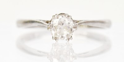 Lot 1267 - An 18ct white gold solitaire ring set with an...