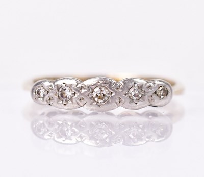 Lot 1358 - A yellow metal ring set with five tiny...