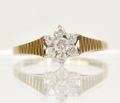 Lot 1338 - A 9ct gold ring with seven diamonds in a...