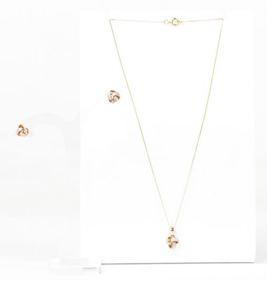 Lot 1486 - A 9ct yellow gold knot-shaped pendant set with...