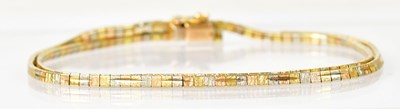 Lot 1403 - An 18ct three-colour two-strand bracelet,...