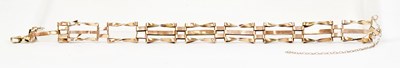 Lot 1420 - A yellow metal three-bar gate bracelet, length...
