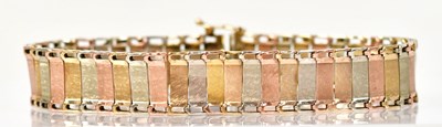 Lot 1416 - A 9ct three-colour gold panel bracelet, length...