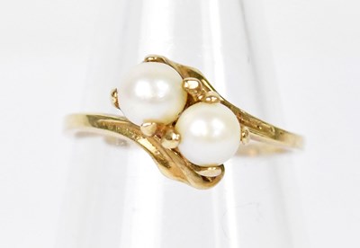 Lot 1315 - A 10ct yellow gold ring set with two pearls,...