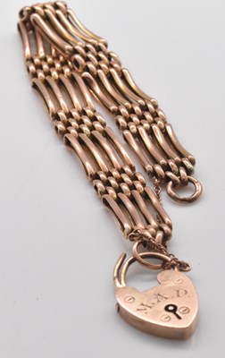 Lot 479 - A 9ct rose gold four bar gatelink bracelet,...