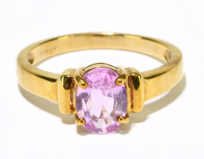 Lot 1228 - A 9ct yellow gold pink sapphire oval solitaire...