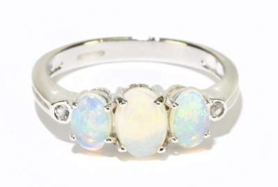 Lot 1203 - A 9ct white gold and three stone opal and...
