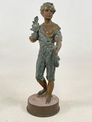 Lot 250 - A metal figure of a boy holding flowers,...