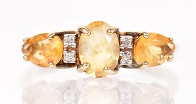 Lot 1348 - A 9ct yellow gold ring set with three yellow...