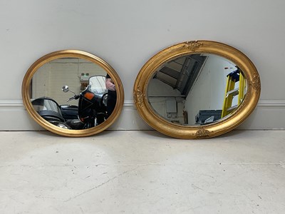 Lot 1049 - Two modern oval wall mirrors, the larger...