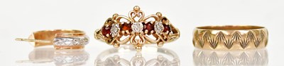 Lot 1353 - A 9ct yellow gold filigree ring set with three...