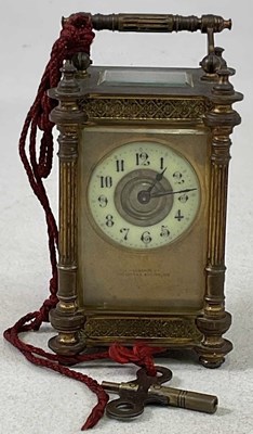 Lot 614 - A circa 1900 brass carriage clock with ornate...
