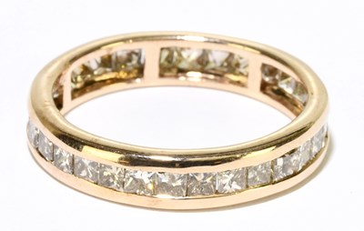 Lot 1202 - A 9ct rose gold diamond set eternity ring with...