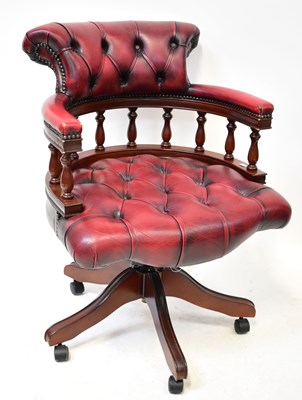 Lot 8 - A red button pressed leather captain's desk...