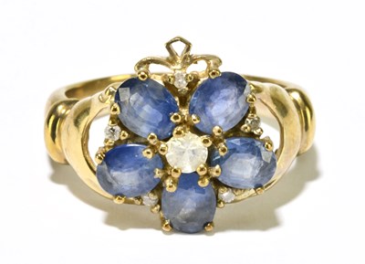 Lot 1182 - A 9ct yellow gold diamond and pale blue stone...