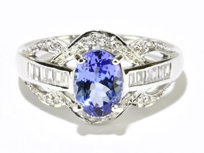 Lot 1089 - An 18ct white gold tanzanite and diamond ring,...