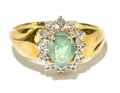 Lot 1221 - A 9ct yellow gold emerald and diamond ring,...