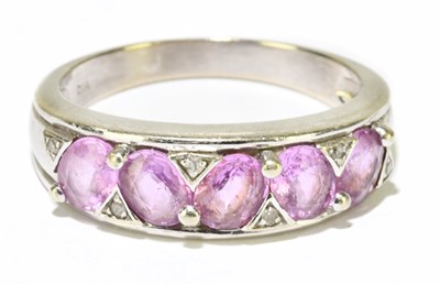 Lot 1183 - A 9ct white gold pink sapphire and diamond...