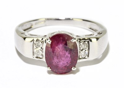 Lot 1083 - An 18ct white gold ruby and diamond ring, size...