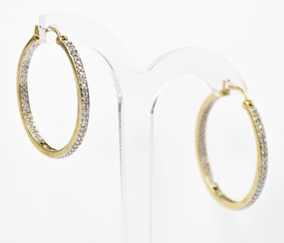 Lot 1374 - A pair of 9ct yellow gold hoop earrings set...
