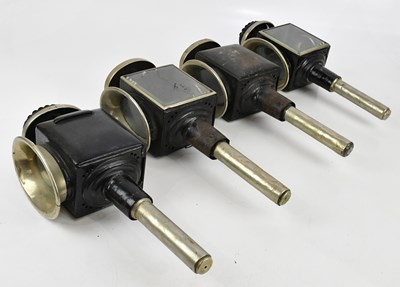Lot 1815 - A set of four black painted carriage lamps,...