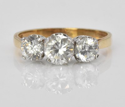 Lot 516 - A 14ct yellow gold three stone dress ring,...