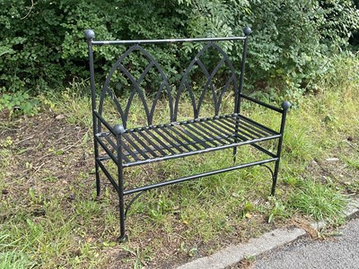 Lot 1221 - A black painted gothic style garden bench,...
