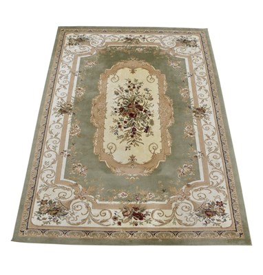Lot 1250 - A large decorative rug with floral sprays on a...